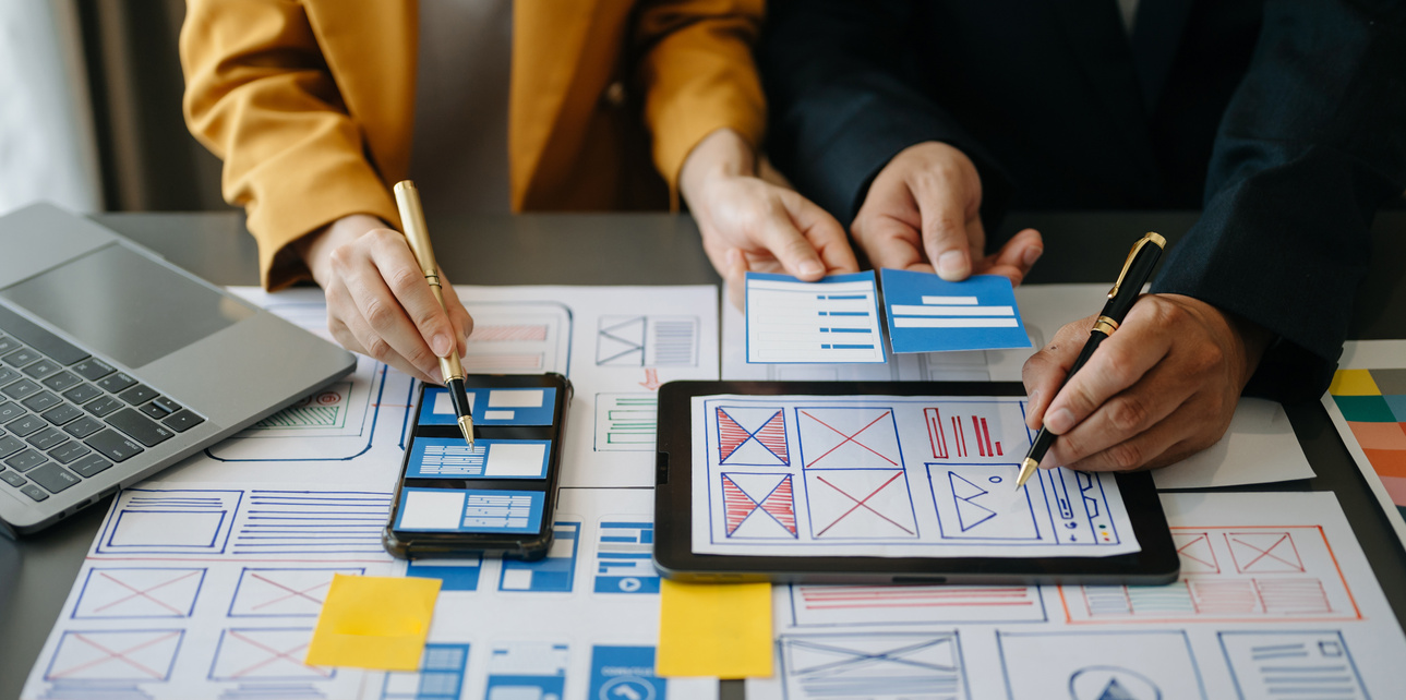 UX graphic designer planning application process development prototype wireframe for web smart phone. Creative digital development agency.